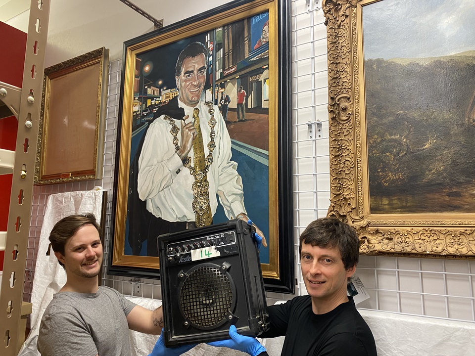 Image of Ben Boardman and Ian Wards at City Archives with Kennys amp in front of former Mayor Mark Blumsky portrait
