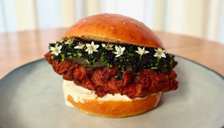 The Atlast Burger containing buttermilk fried chicken with caviar, housemade seaweed hot sauce and Zany Zeus crème fraîche in a housemade potato bun. 