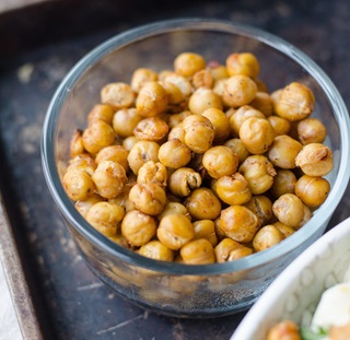 A glass bowl full of chickpeas.