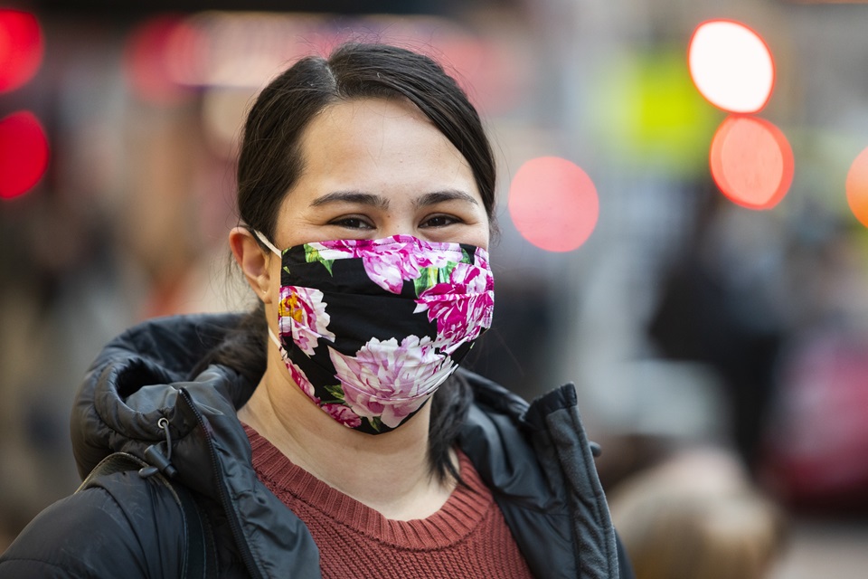 Young woman wearing floral coloured COVID mask