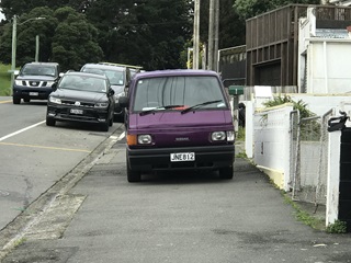 A van parked on a footpath.