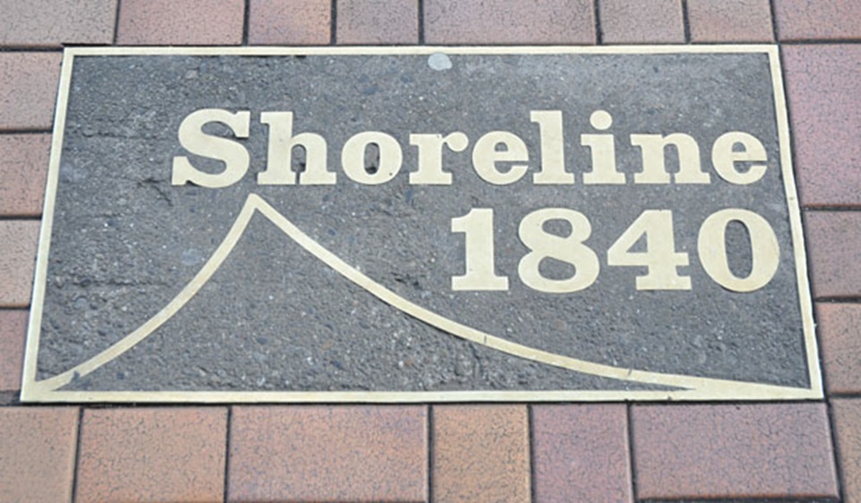 A plaque on a tiled footpath that reads 