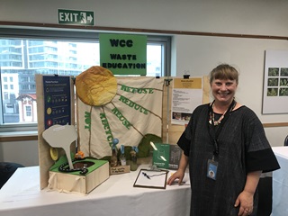Joanna Langford standing in front of a beautiful waste minimisation display board.