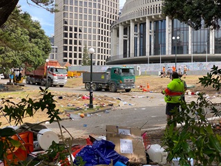 Two trucks drive into Parliament to clean up rubbish.