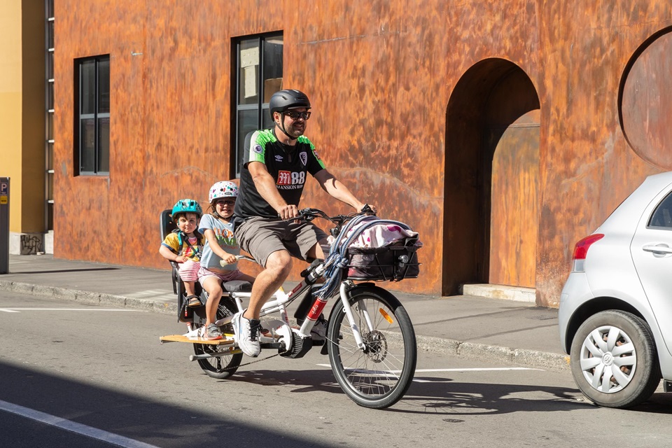 Image of person on bicycle with children