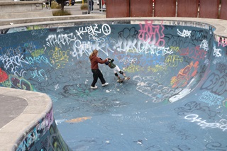 Person teaching a child how to skate.