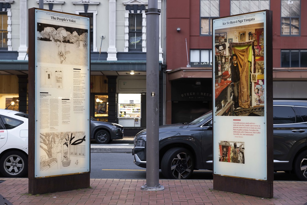Courtenay Place Lightbox Exhibition two artworks on display at dusk.