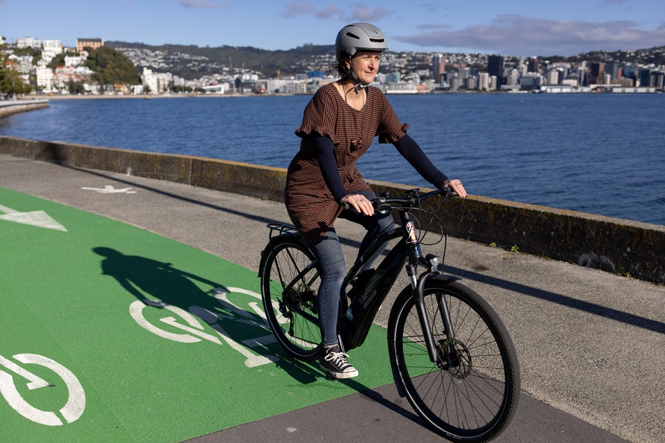 Cyclist on cycleway around the bays with harbour in background.