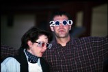 Couple of people with 2000 shaped glasses on celebrating at New Year's Eve event 31 December 1999
