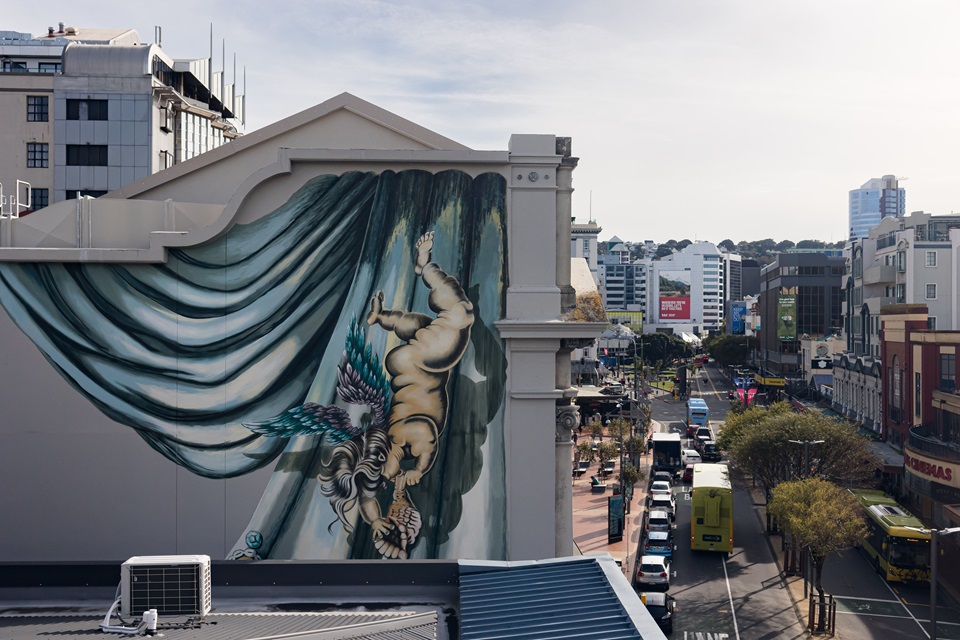 Top corner of St James with cherub from mural in forefront with Courtenay Place in the background.