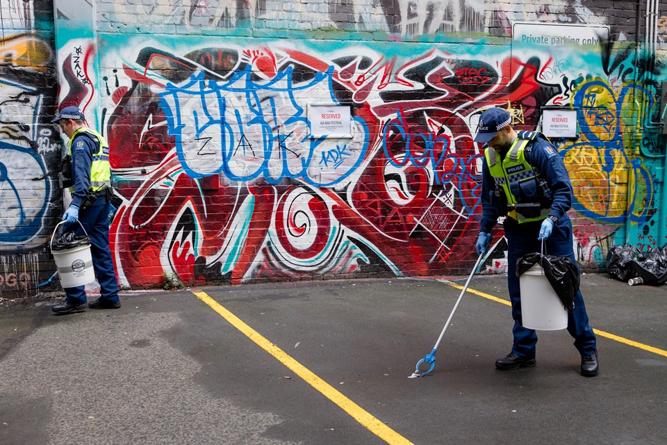 Police cleaning up litter in a carpark.