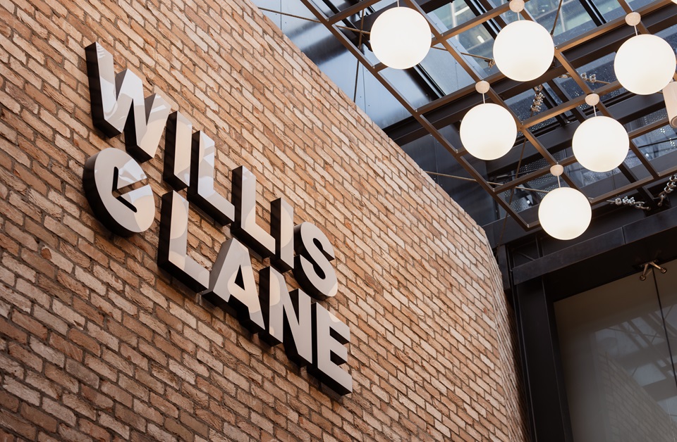 Brick wall with a sign reading 'Willis lane'.