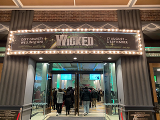 Sign at the entrance to a theatre reading 'wicked'.