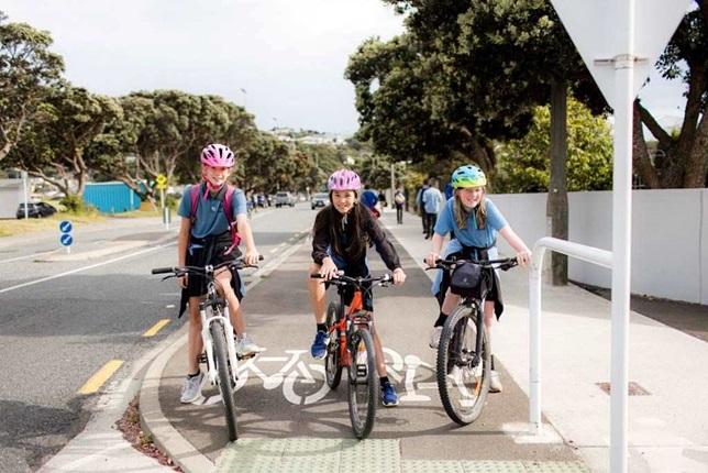 Three young people on bikes on shared pathway