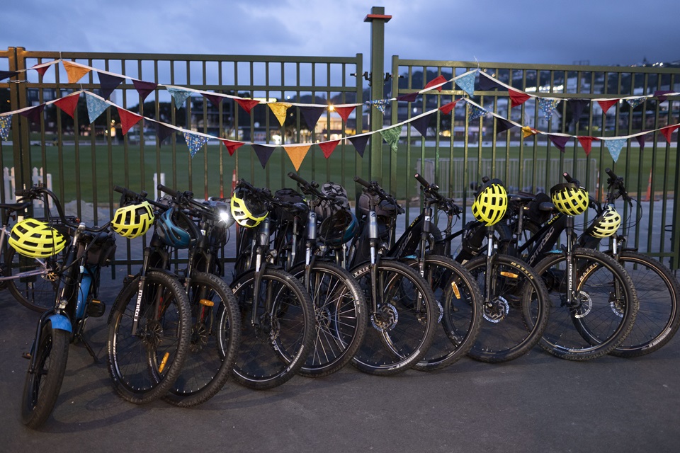 Bikes lined up at fence with flags at Newtown to City official route launch at Basin reserve.
