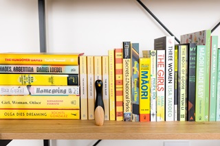 Bookshelf with yellow books lined up.