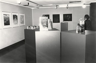A black and white photo of the first ever exhibition at City Gallery which features plinths with sculptures and pictures on the walls.