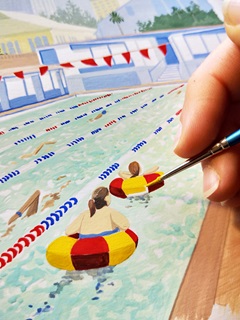 A hand holding a paintbrush over a bright watercolour painting of an outdoor pool.