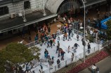 Looking down on the ice rink showing kids and adults having fun.