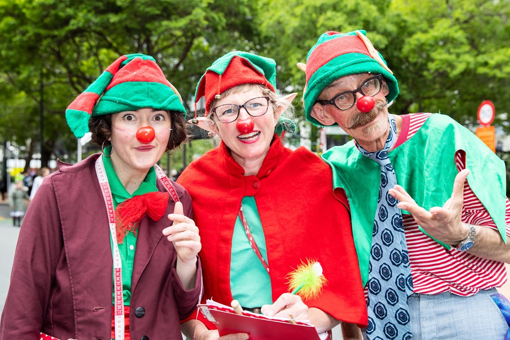 Three performers dressed as elves.