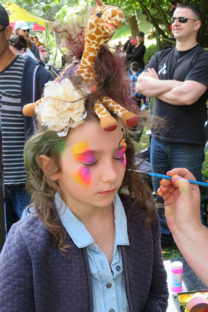 A child getting their face painted.