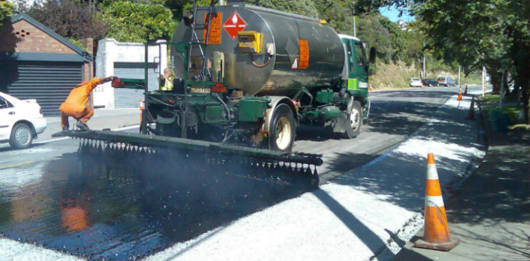 Spraying bitumen on the road.