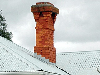 Unreinforced masonry chimney.