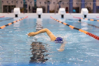Person swimming in one of the main pool lanes at Wellington Regional Aquatic Centre. 