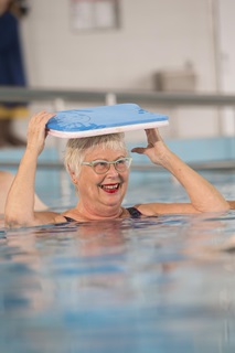 Smiling woman enjoying a hydrotherapy class. 