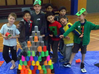 Children with tower of colourful plastic cups.
