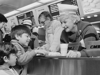 Kapiti MP and Consumer Affairs Minister Margaret Shields serves nephews at Porirua McDonalds as part of a McHappy promotion in 1986. Photo courtesy of Evening Post.